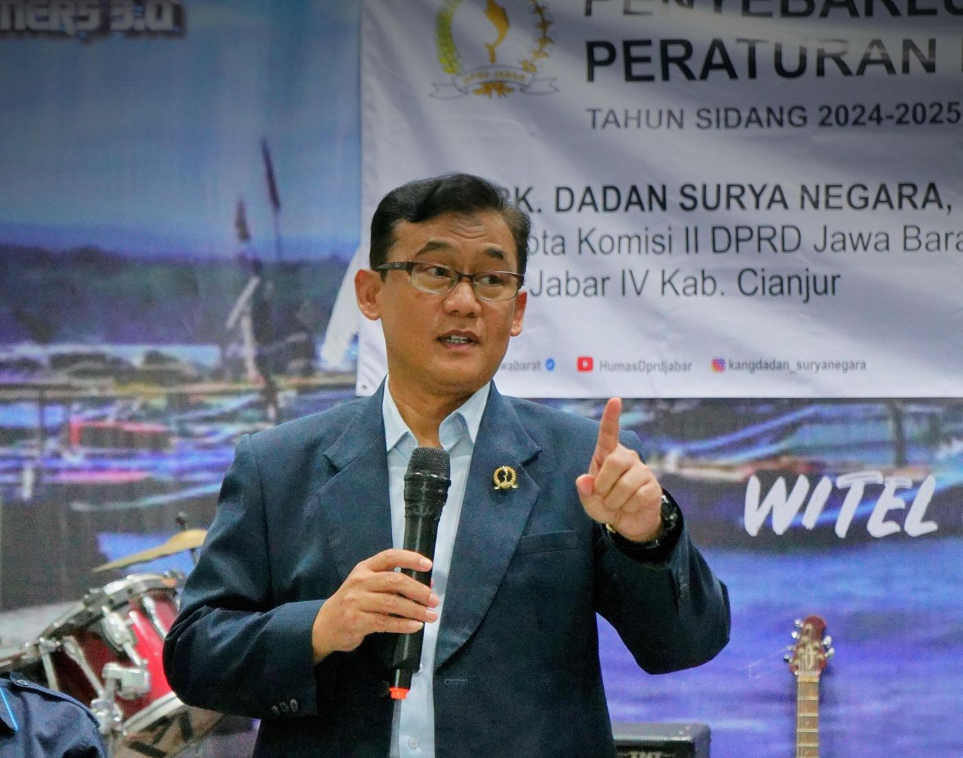 Kang Dadan berbicara di depan warga sambil memegang mikrofon